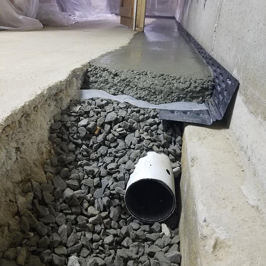 Interior French drain installation for a dry basement